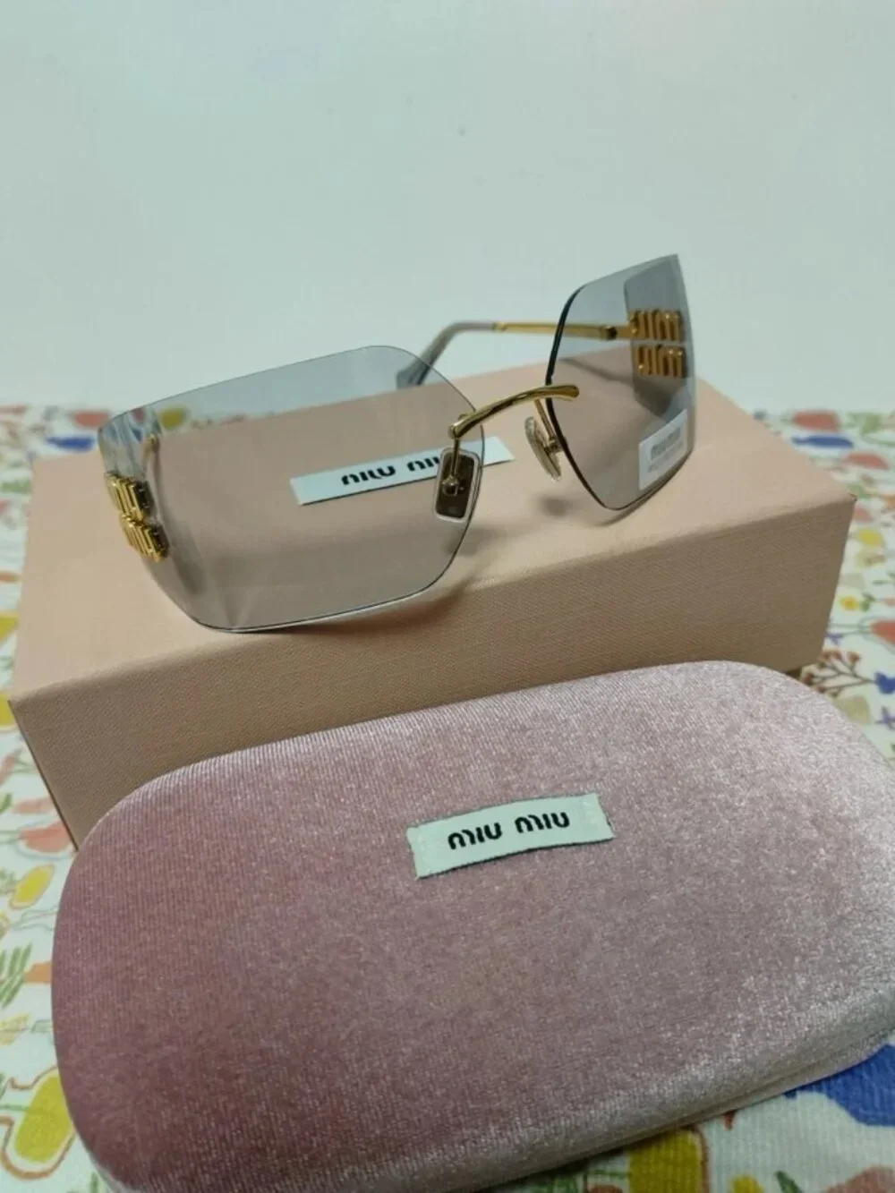 Miu Miu Rimless Grey Sunglasses with Oversized Gold Logo